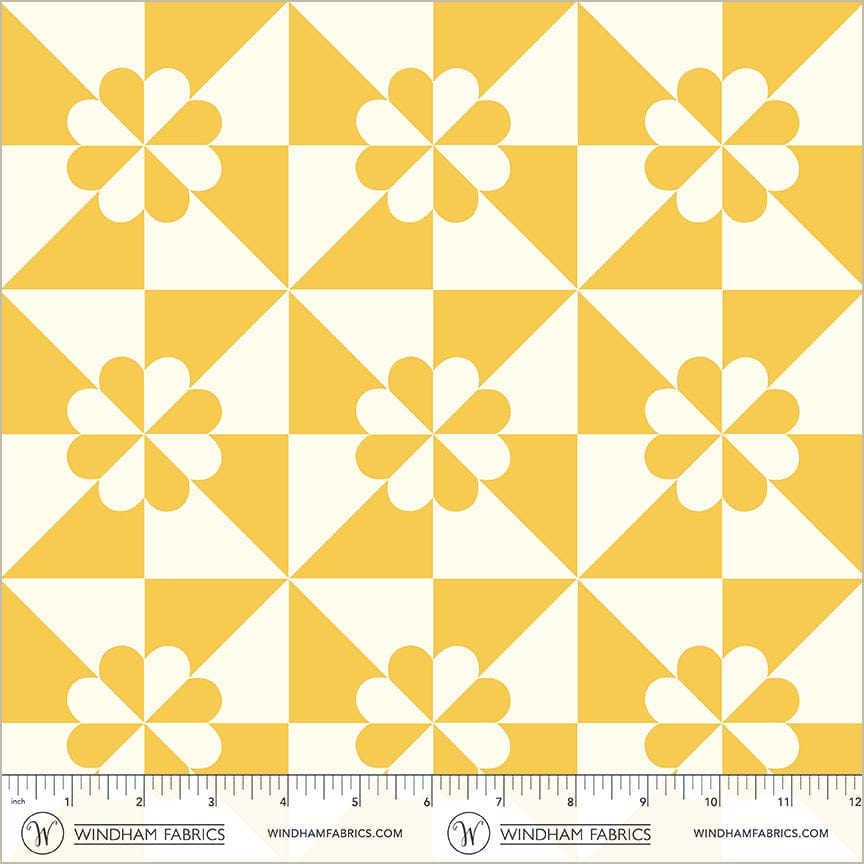 A closeup shot of the quilting fabric pattern called Hearts and Gizzards, designed by Whistler Studios, in the yellow colorway. The SKU is 54881-5.