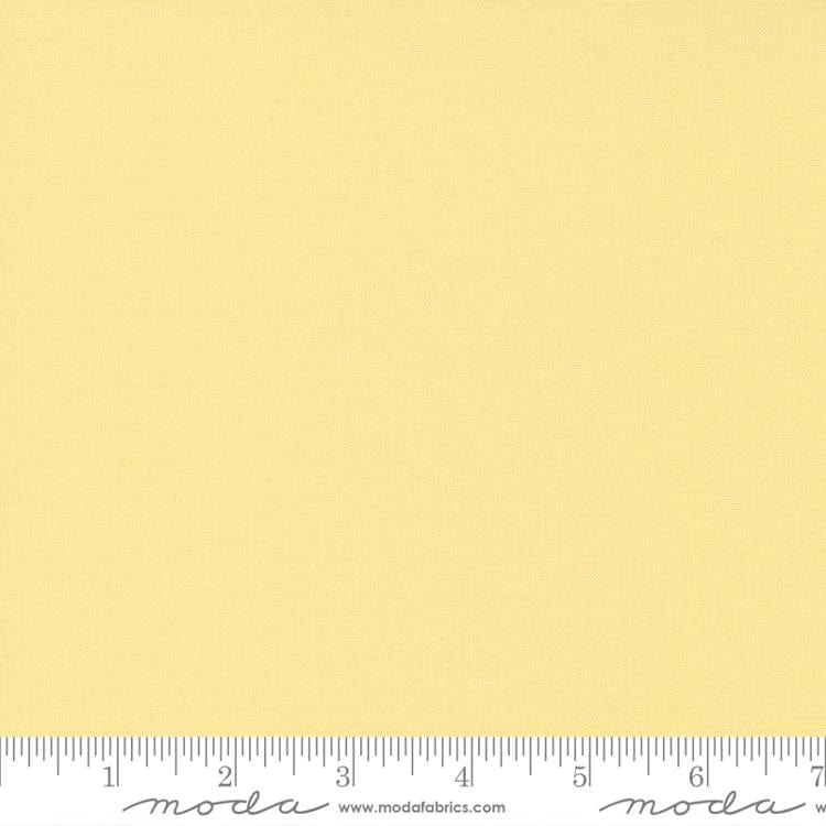Cotton quilting fabric pattern called 'Baby Yellow'. Part of the 'Bella Solids' fabric collection. Designed by Moda Fabrics for fabric company Moda Fabrics. SKU: 9900 31. 44-45 inch width.