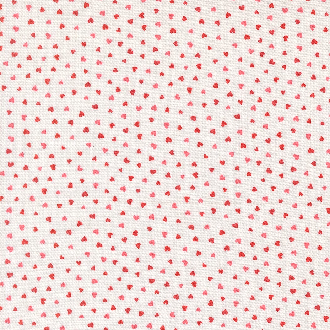 A closeup shot of the quilting fabric pattern called Tiny Hearts, designed by Lizzy House, in the champagne colorway. The SKU is 37148 11.