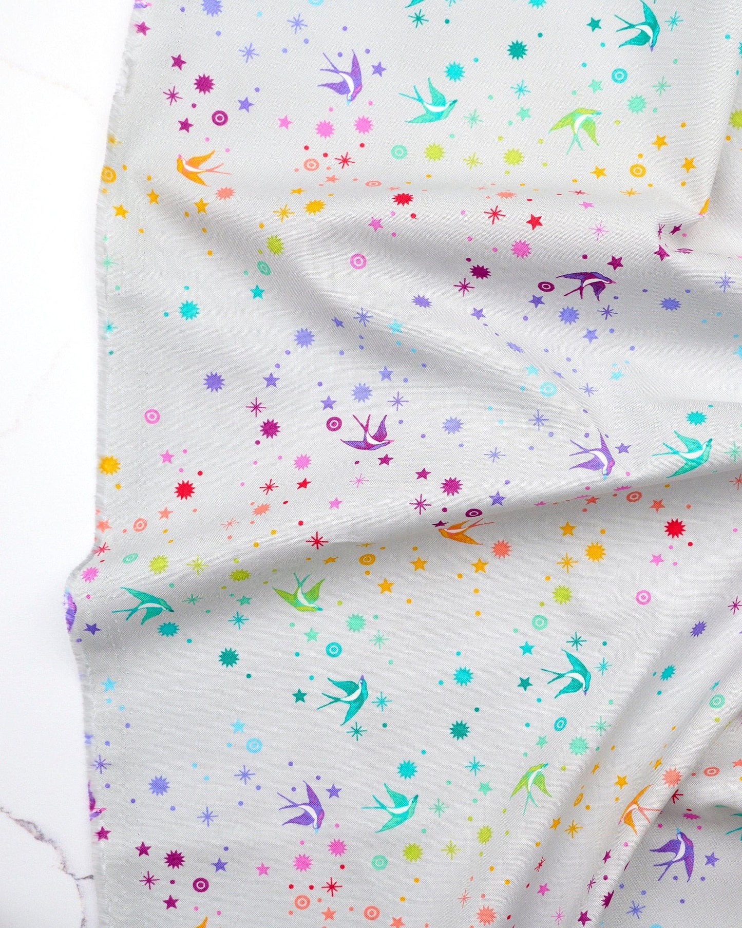 Fairy Dust in Fog quilting fabric, part of the Fall 2025 True Colors fabric collection by Tula Pink (SKU: PWTP133.FOG)