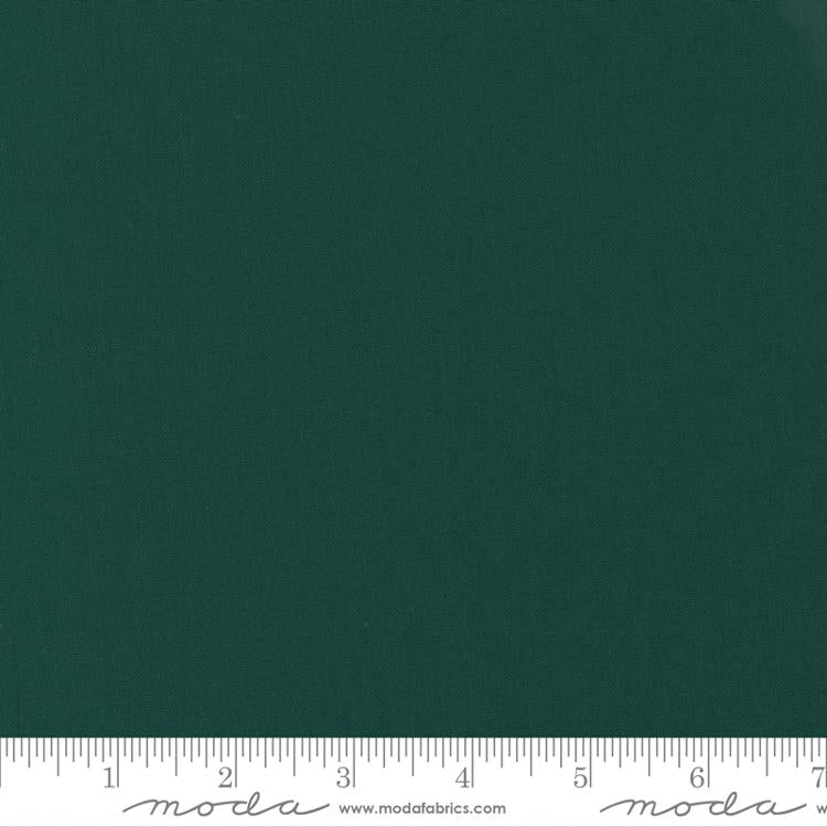 Cotton quilting fabric pattern called 'Christmas Green'. Part of the 'Bella Solids' fabric collection. Designed by Moda Fabrics for fabric company Moda Fabrics. SKU: 9900 14. 44-45 inch width.