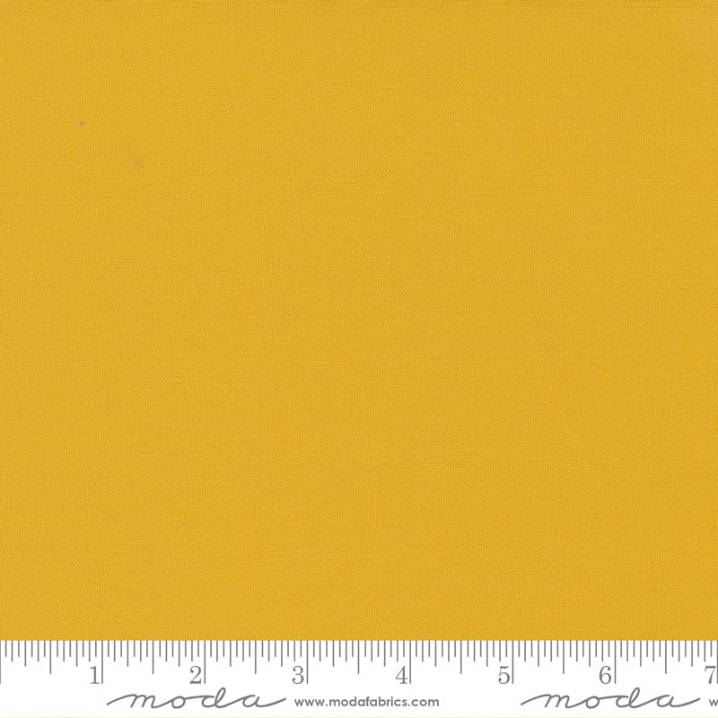 Cotton quilting fabric pattern called 'Mustard'. Part of the 'Bella Solids' fabric collection. Designed by Moda Fabrics for fabric company Moda Fabrics. SKU: 9900 213. 44-45 inch width.