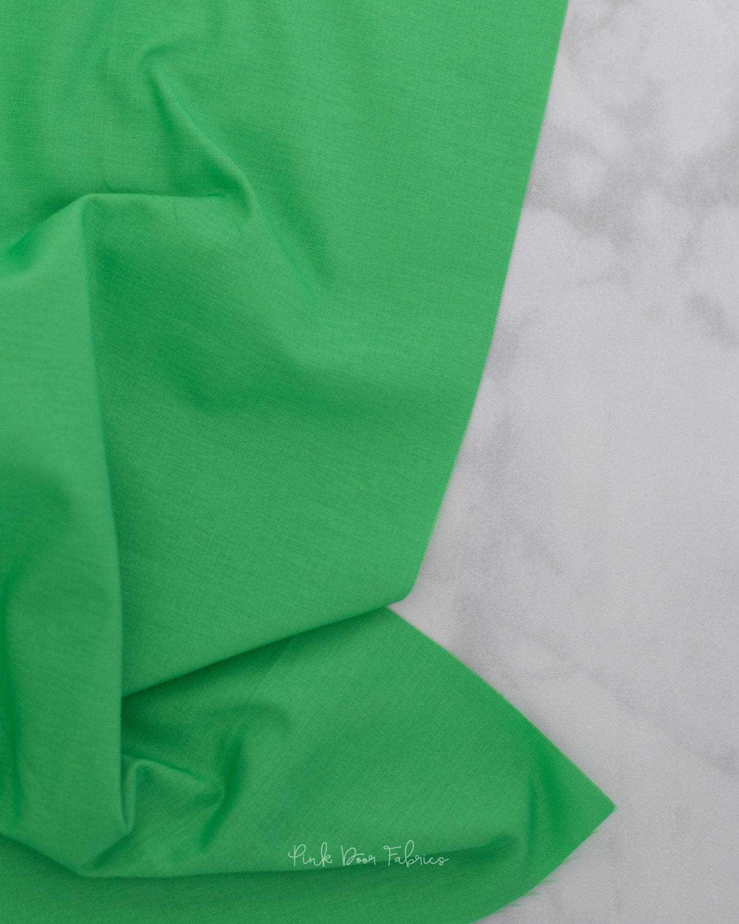 Cotton quilting fabric pattern called 'Solid in Cricket'. Part of the 'True Colors' fabric collection. Designed by Tula Pink for fabric company Free Spirit Fabrics. SKU: CSFSESS.CRICKET. 44-45 inch width.