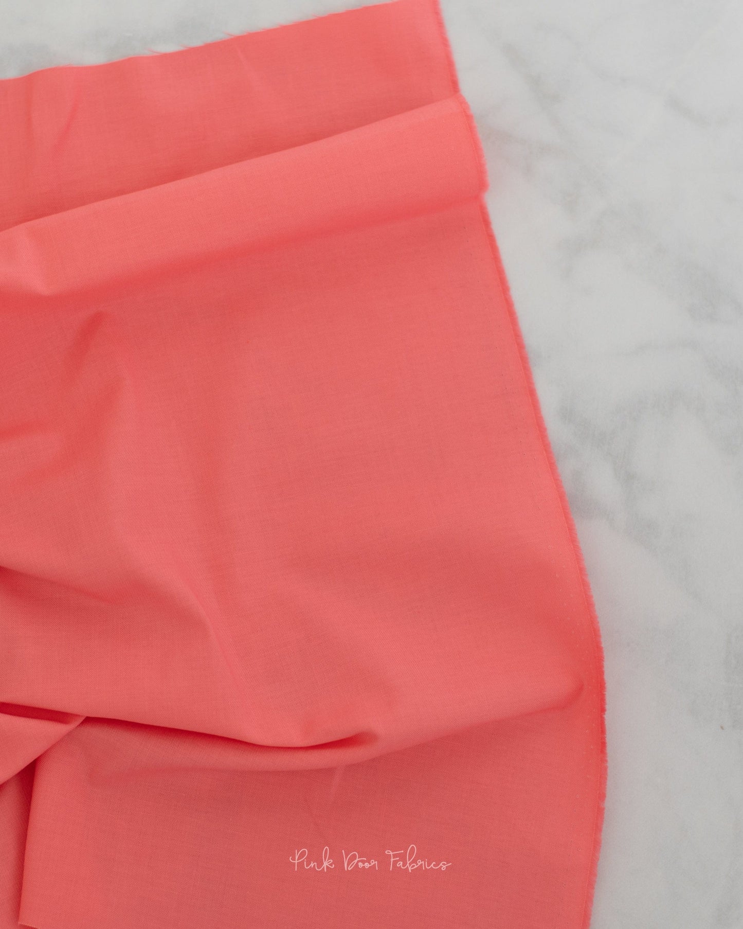 Cotton quilting fabric pattern called 'Solid in Taffy'. Part of the 'True Colors' fabric collection. Designed by Tula Pink for fabric company Free Spirit Fabrics. SKU: CSFSESS.TAFFY. 44-45 inch width.