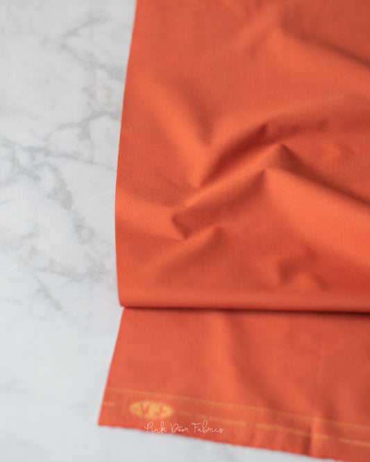 Cotton quilting fabric pattern called 'Terracotta Tile'. Part of the 'Pure Solids' fabric collection. Designed by Art Gallery Fabrics for fabric company Art Gallery Fabrics. SKU: PE-508. 44-45 inch width.