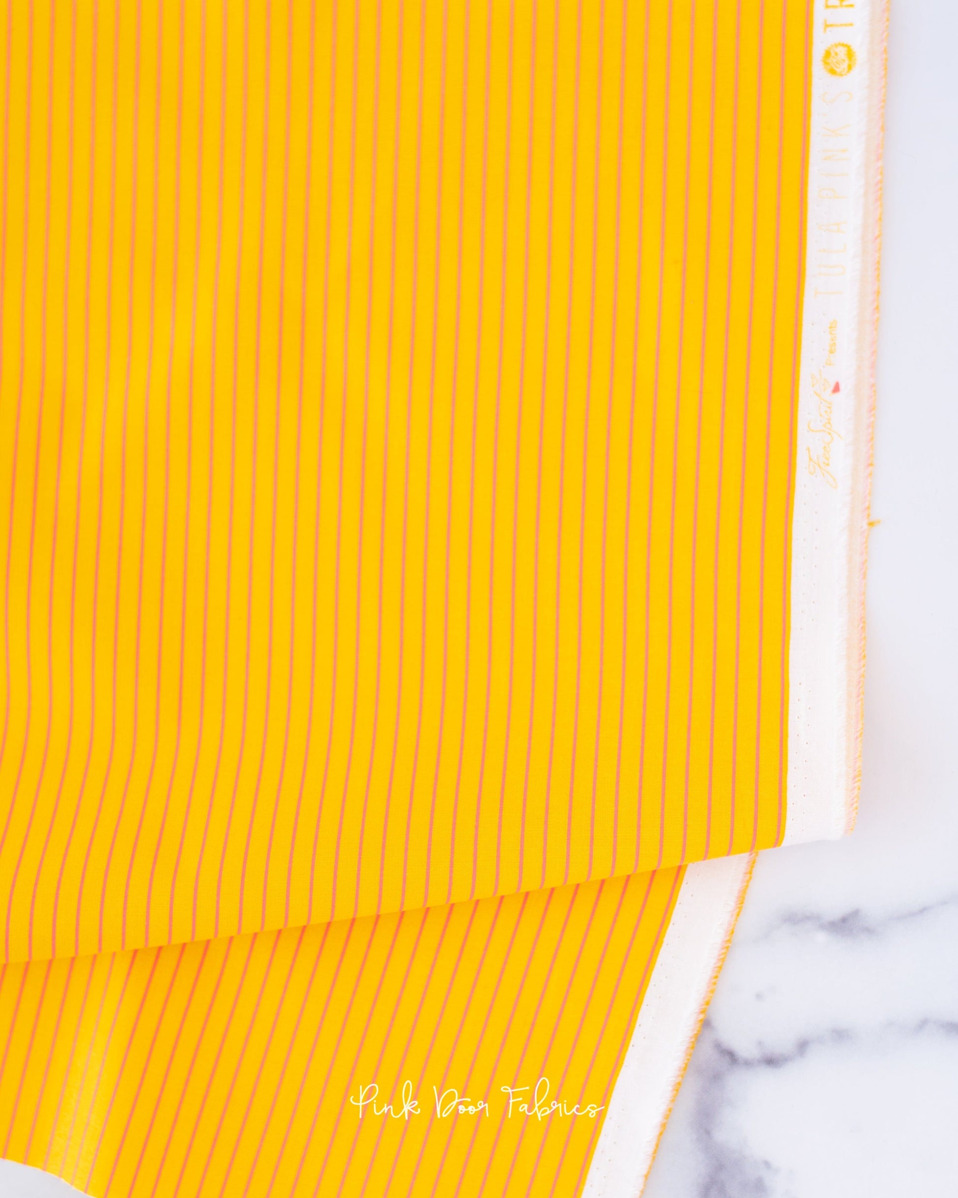 Cotton quilting fabric pattern called 'Tiny Stripes in Sunrise'. Part of the 'True Colors' fabric collection. Designed by Tula Pink for fabric company Free Spirit Fabrics. SKU: PWTP186.SUNRISE. 44-45 inch width.