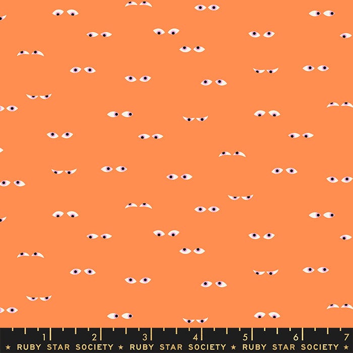 Cotton quilting fabric pattern called 'Creepy Eyes in Pumpkin Glow in the Dark'. Part of the 'Tiny Frights' fabric collection. Designed by Ruby Star Society for fabric company Moda Fabrics. SKU: RS5120 11G. 44-45 inch width.