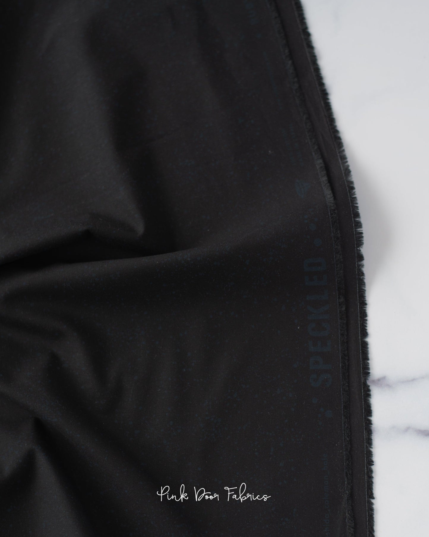 Cotton quilting fabric pattern called 'Onyx'. Part of the 'Speckled Metallic' fabric collection. Designed by Ruby Star Society for fabric company Moda Fabrics. SKU: RS5027 102. 44-45 inch width.