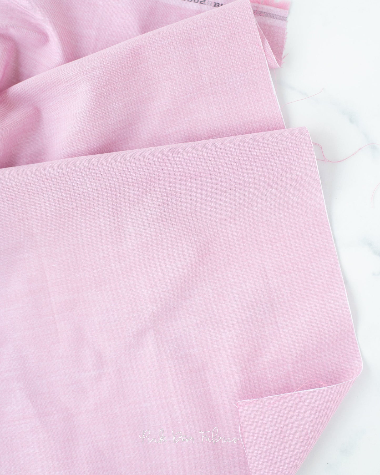 Chambray quilting fabric pattern called 'Blush'. Part of the 'Chambray Solids' fabric collection. Designed by Tilda Fabrics for the Tilda Fabrics fabric company. SKU: 160002. 44-45 inch width.