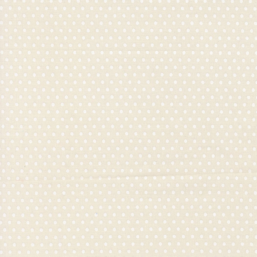 A closeup shot of the quilting fabric pattern called Dotty Dot, designed by Stacy Iest Hsu, in the dove-natural colorway. The SKU is 20967 21.