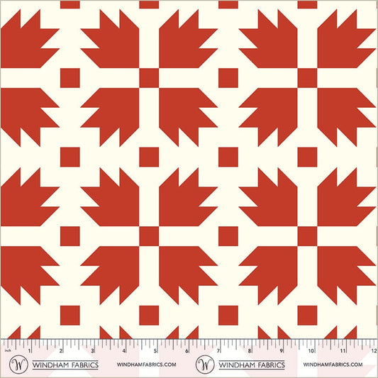 A closeup shot of the quilting fabric pattern called Bear Paw, designed by Whistler Studios, in the red colorway. The SKU is 54879-1.