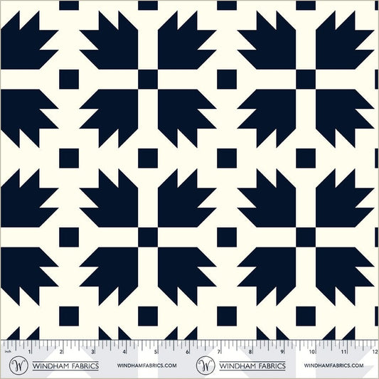 A closeup shot of the quilting fabric pattern called Bear Paw, designed by Whistler Studios, in the navy colorway. The SKU is 54879-2.