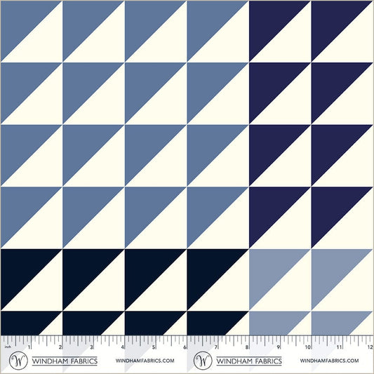 A closeup shot of the quilting fabric pattern called Half Square Triangle, designed by Whistler Studios,, in the blues colorway. The SKU is 54884-9.