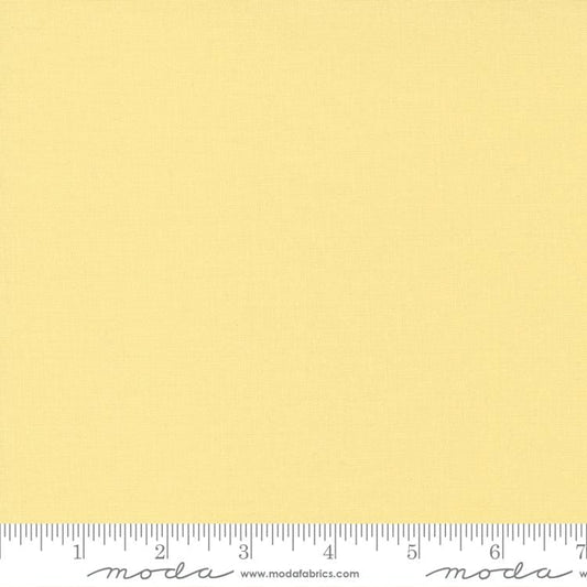 Cotton quilting fabric pattern called 'Baby Yellow'. Part of the 'Bella Solids' fabric collection. Designed by Moda Fabrics for fabric company Moda Fabrics. SKU: 9900 31. 44-45 inch width.