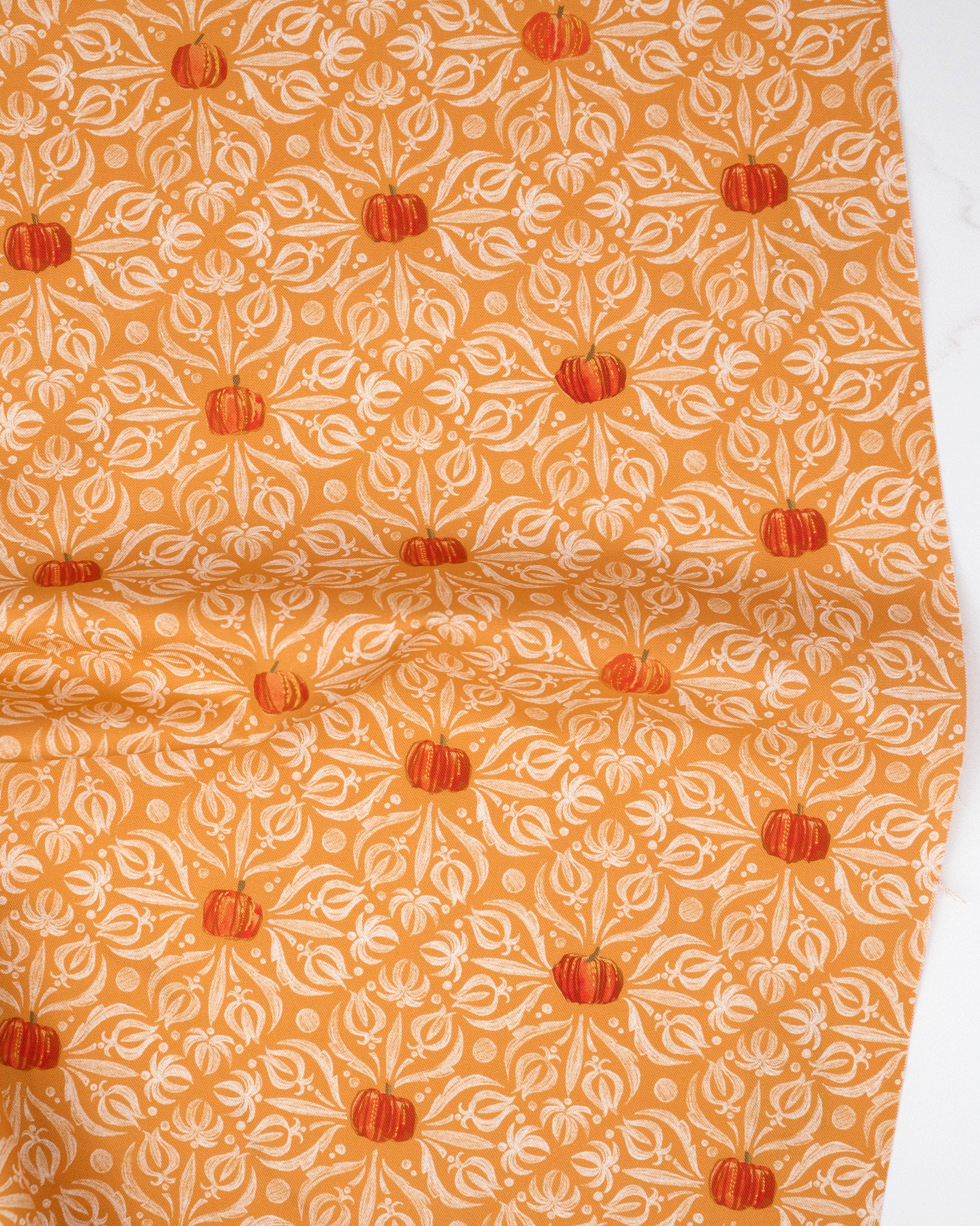Medallion Tiles Damask Pumpkin quilting fabric, part of the Coven fabric collection by Robin Pickens (SKU: 48802 12)