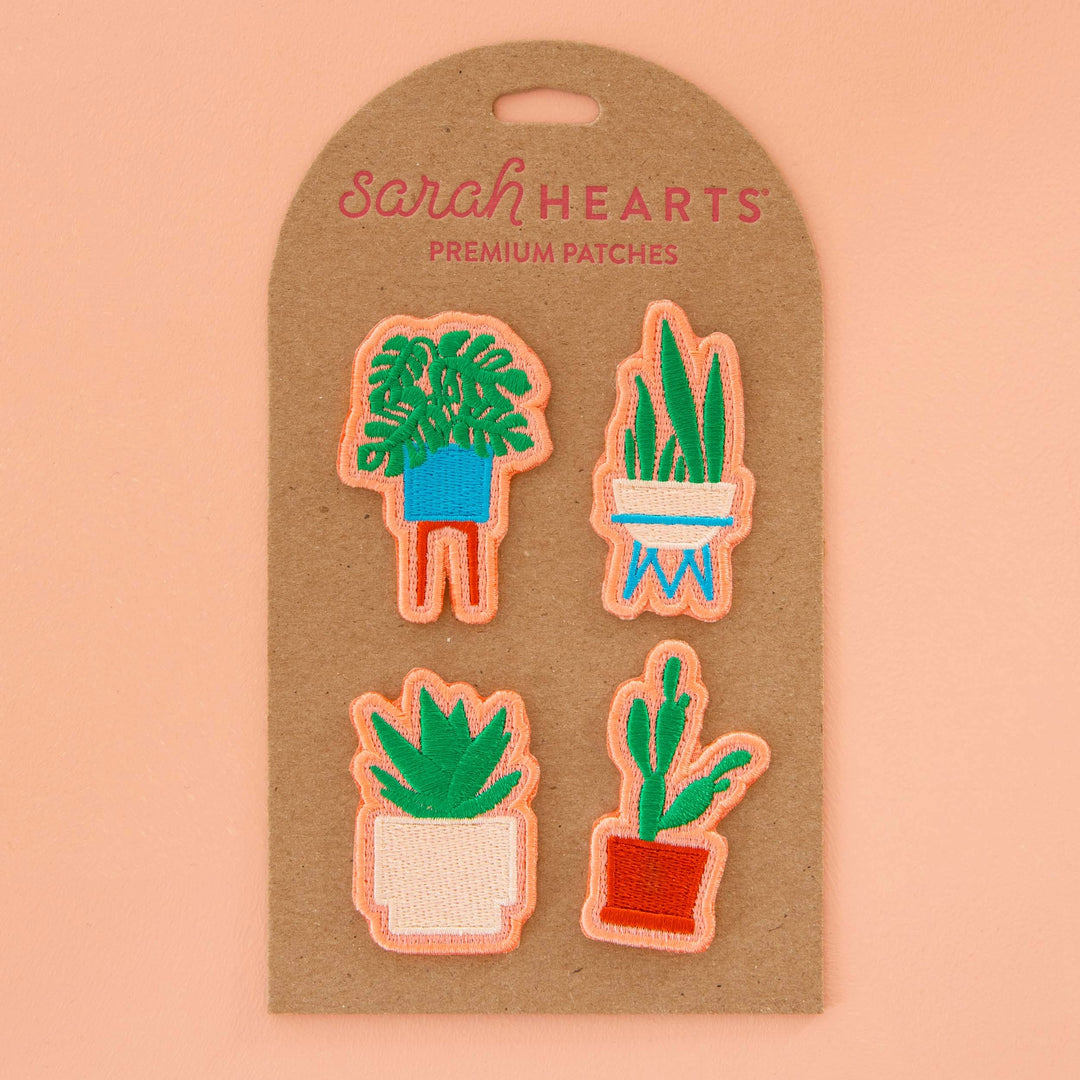 Bring a little of the outdoors in with these fun houseplant patches. These patches showcase succulents, snake plants, cacti, and monsteras in a mid century style. Get creative and stick them on anything that needs a little greenery. Sewing recommended for longer use.  Sold in 4 patches per unit, one of each design  Each approximately 5 cm x 5 cm / 2" x 2"  Manufactured ethically in China and are OEKO-TEX Standard 100 certified