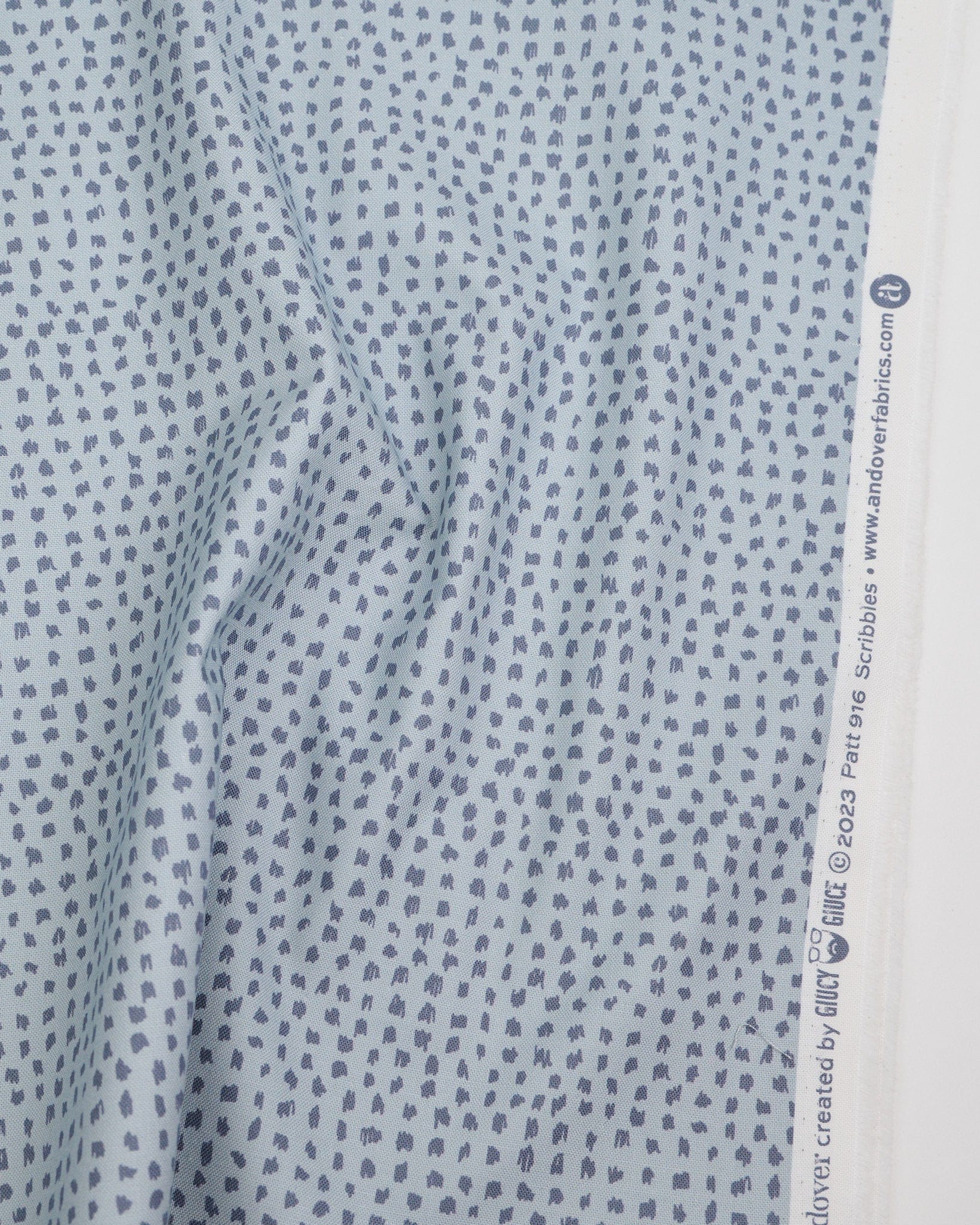 Cotton quilting fabric pattern called 'Scribbles in Moon'. Part of the 'Ink by Giucy Giuce' fabric collection. Designed by Giucy Giuce for fabric company Andover Fabrics. SKU: A-916-CL. 44-45 inch width.