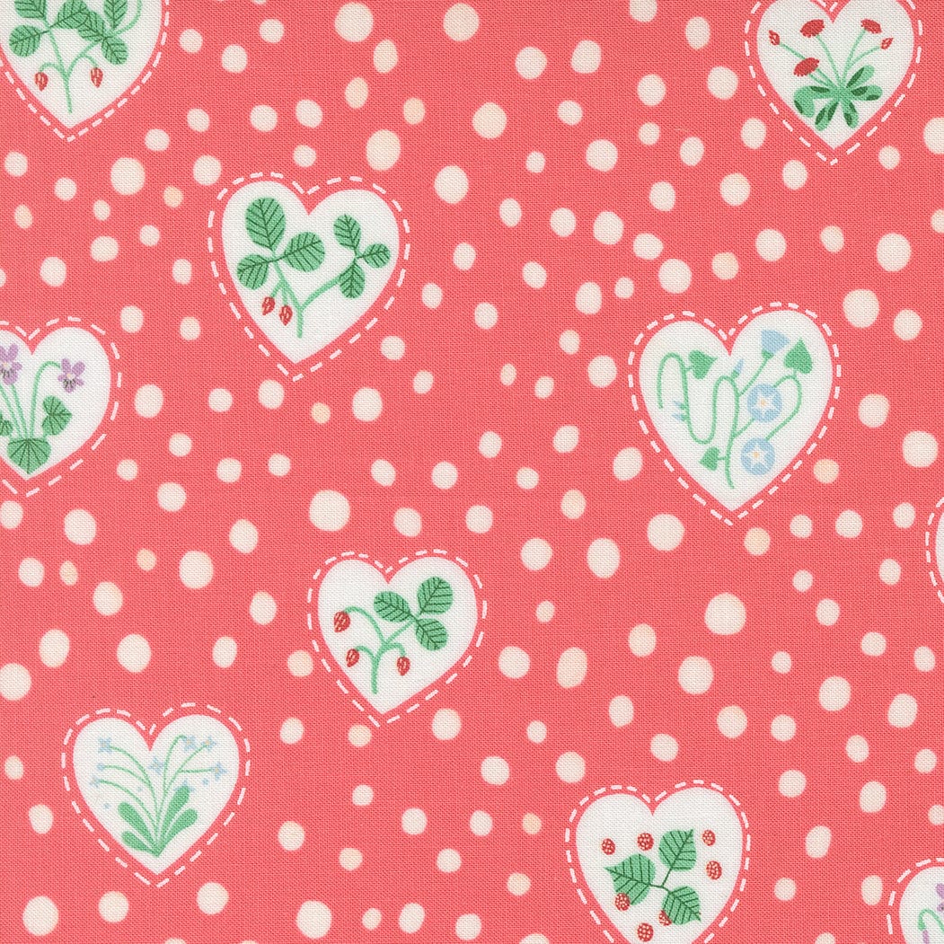 A closeup shot of the quilting fabric pattern called Flower Heart, designed by Lizzy House, in the coral colorway. The SKU is 37144 14.