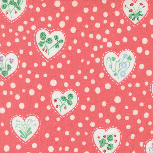 A closeup shot of the quilting fabric pattern called Flower Heart, designed by Lizzy House, in the coral colorway. The SKU is 37144 14.
