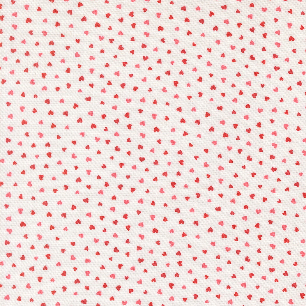 A closeup shot of the quilting fabric pattern called Tiny Hearts, designed by Lizzy House, in the champagne colorway. The SKU is 37148 11.