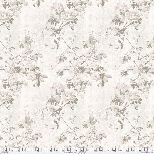 A piece of cotton fabric with a floral pattern in varying shades of gray and white, labeled with the brand Free Spirit Fabrics and the collection name Enrapture.