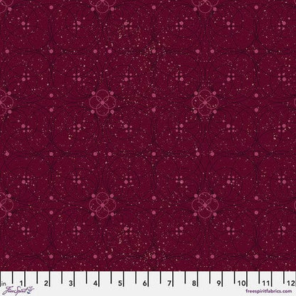A swatch of 'Flourish in Garnet' fabric from the 'Enrapture' collection by Giucy Giuce for Free Spirit Fabrics, displaying a floral pattern on a garnet red background.