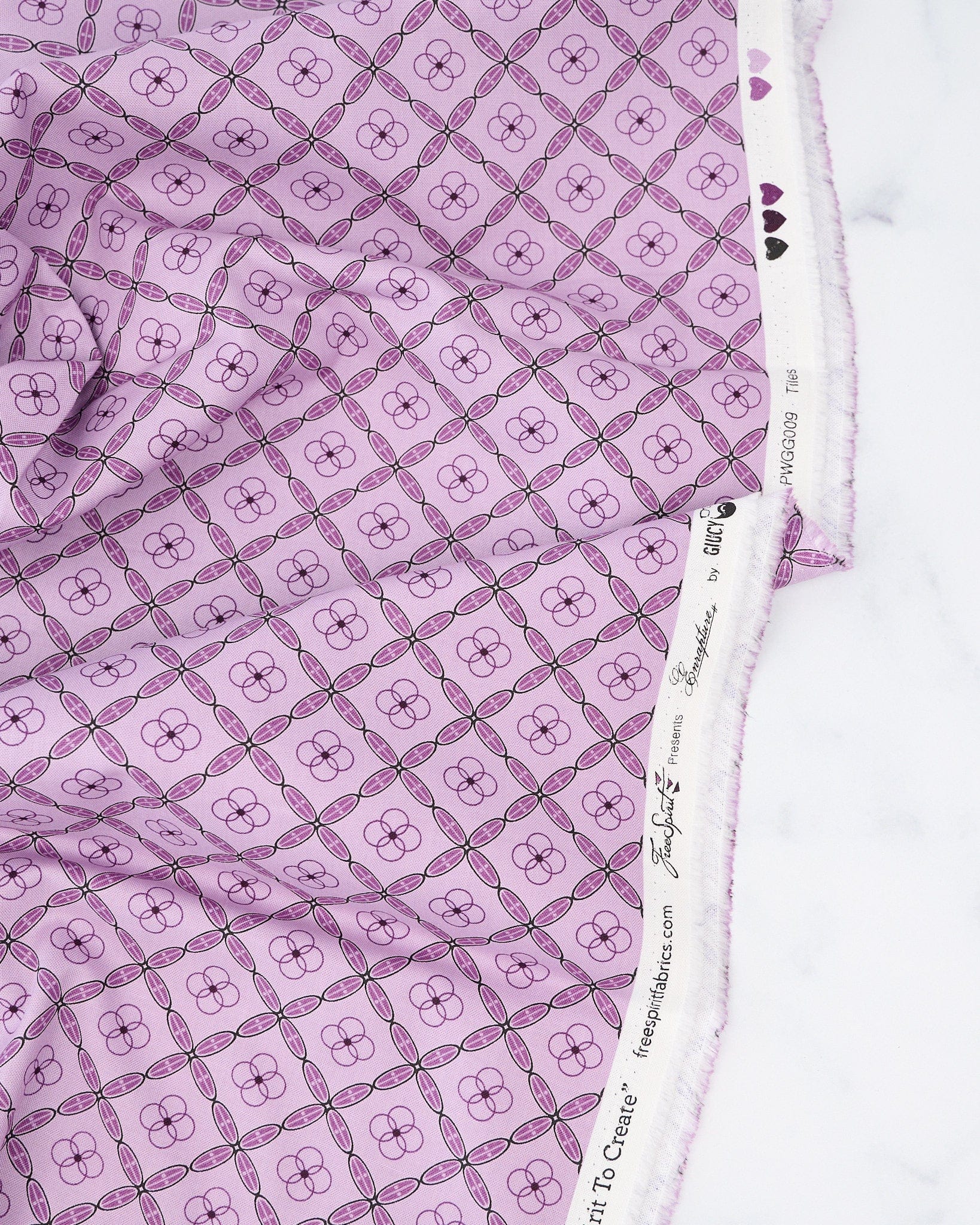 A quilt fabric with a geometric tile pattern in amethyst purple color.