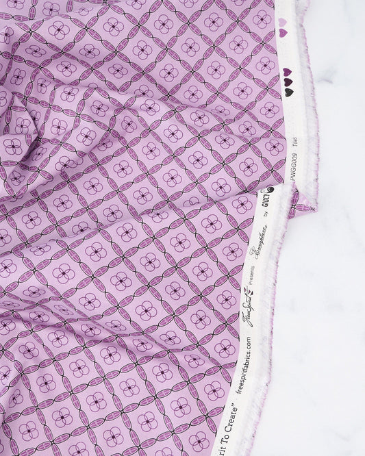A quilt fabric with a geometric tile pattern in amethyst purple color.