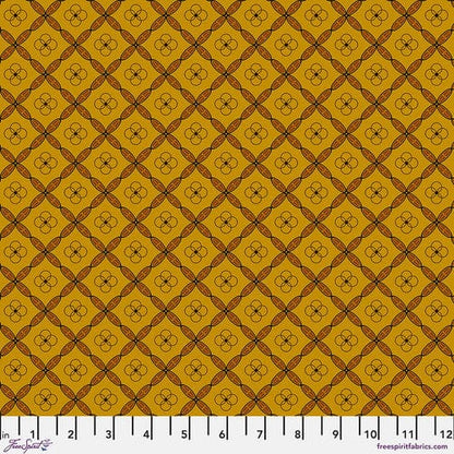A swatch of fabric featuring a geometric tile pattern in various shades of orange and brown.
