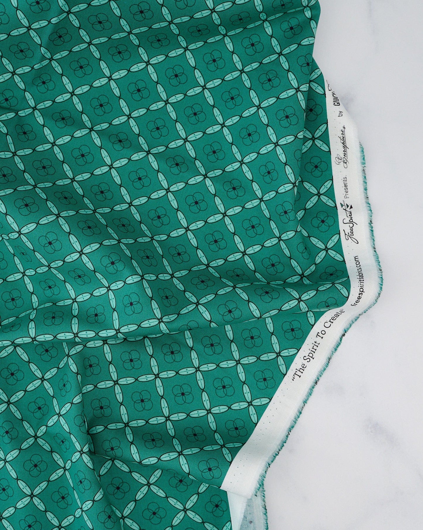A woven patterned fabric in Emerald green, featuring a geometric tile design.


