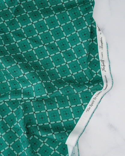 A woven patterned fabric in Emerald green, featuring a geometric tile design.


