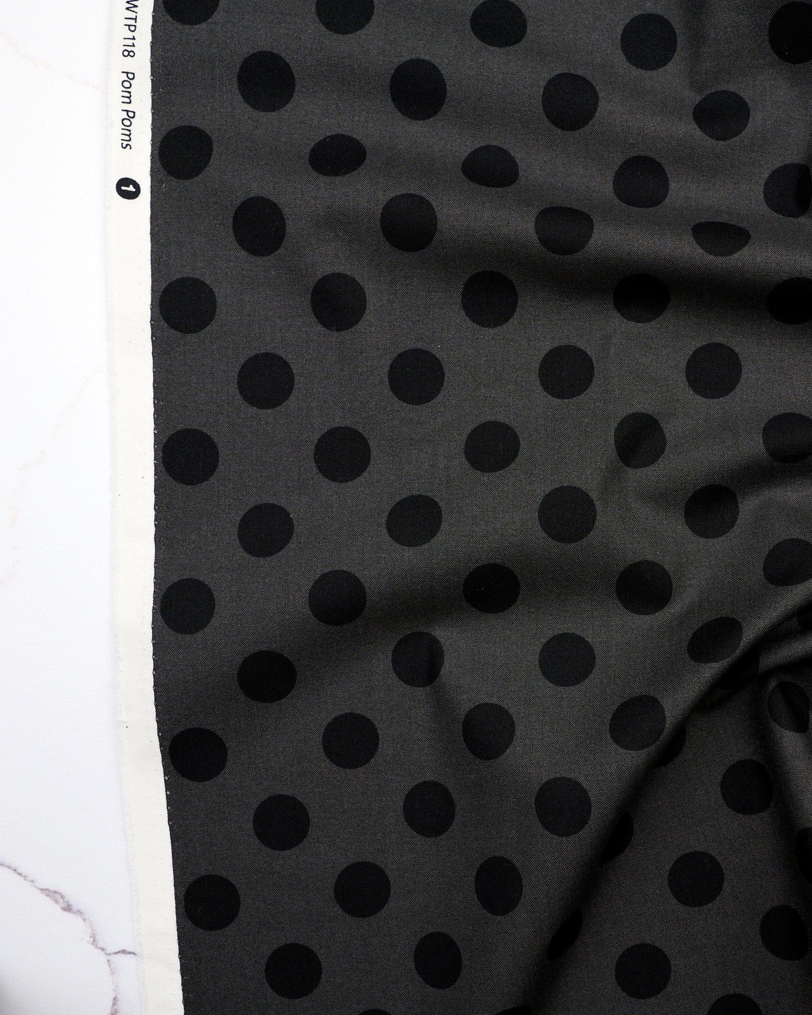 Pom Poms in Carbon quilting fabric, part of the Fall 2025 True Colors fabric collection by Tula Pink (SKU: PWTP118.CARBON)