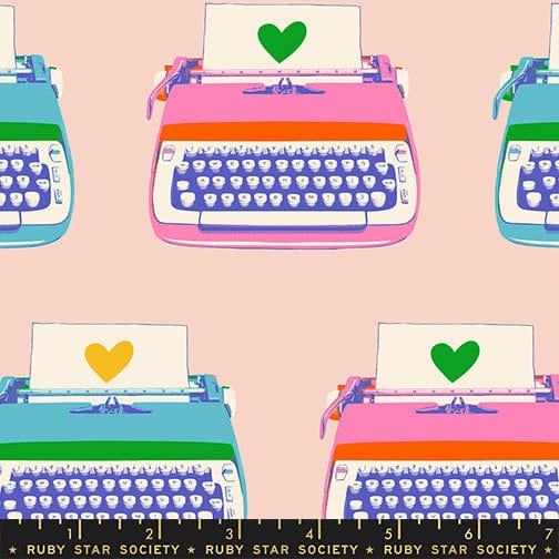 A closeup shot of the quilting fabric pattern called Typewriters, designed by Melody Miller for Ruby Star Society, in the vintage pink colorway. The SKU is RS0104 13.