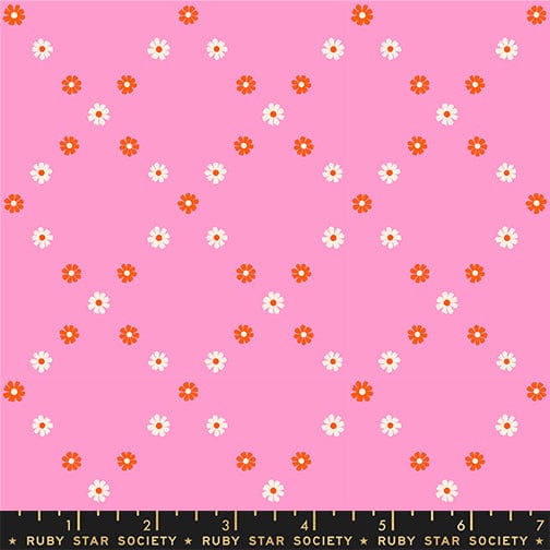 A closeup shot of the quilting fabric pattern called Diamond Flowers, designed by Melody Miller for Ruby Star Society, in the flamingo colorway. The SKU is RS0107 14.
