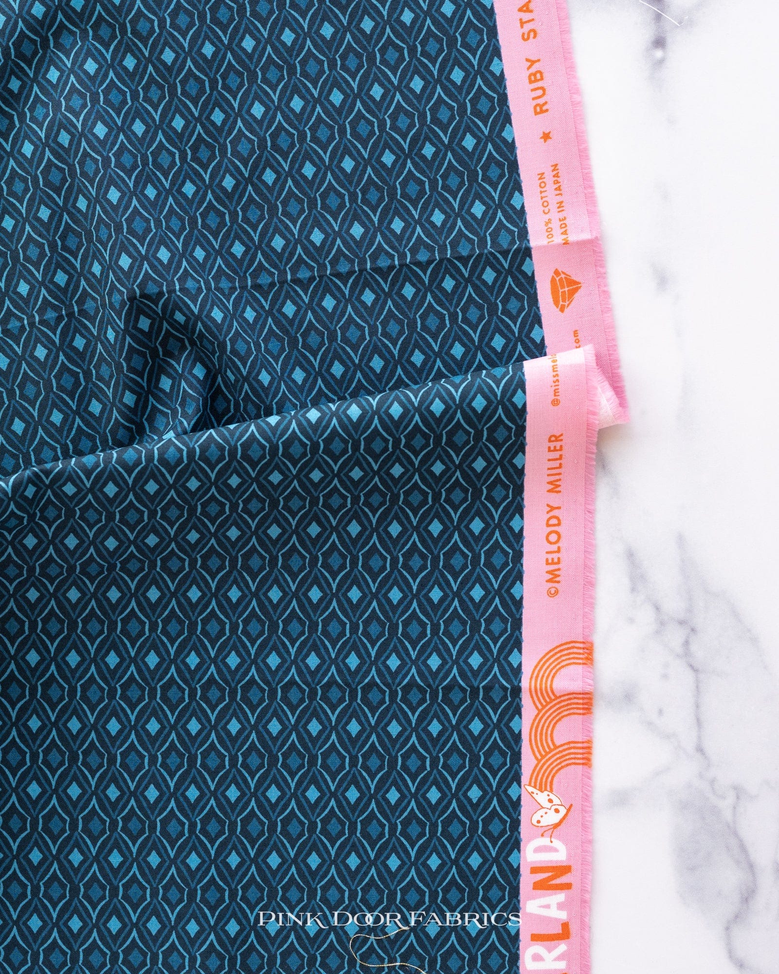 Cotton quilting fabric pattern called 'Diamonds in Peacock'. Part of the 'Flowerland' fabric collection. Designed by Melody Miller of Ruby Star Society for fabric company Moda Fabrics. SKU: RS0070 14. 44-45 inch width.