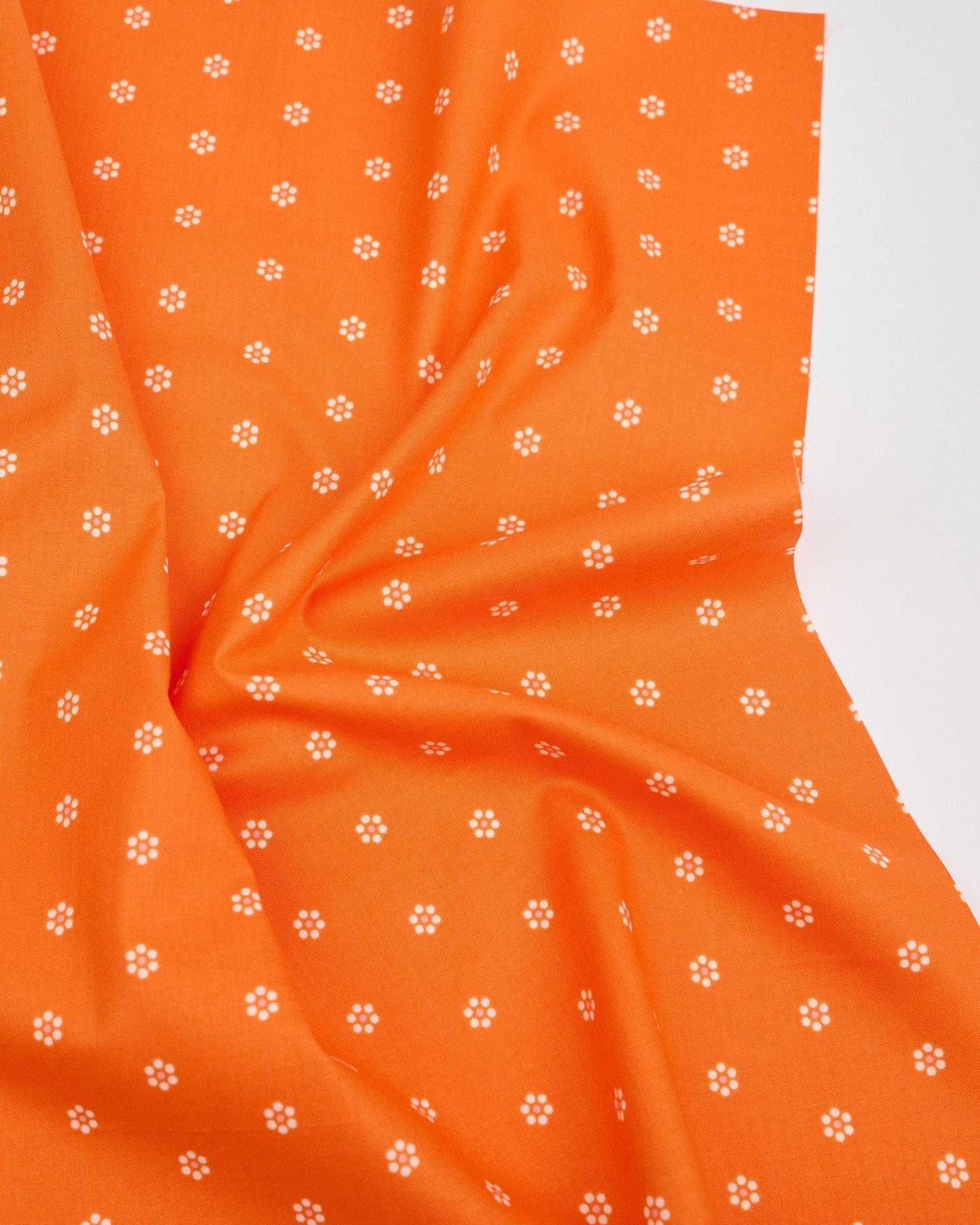 Cotton quilting fabric pattern called 'Tiny Blooms in Orange'. Part of the 'Rise and Shine' fabric collection. Designed by Melody Miller of Ruby Star Society for fabric company Moda Fabrics. SKU: RS0083 14. 44-45 inch width.