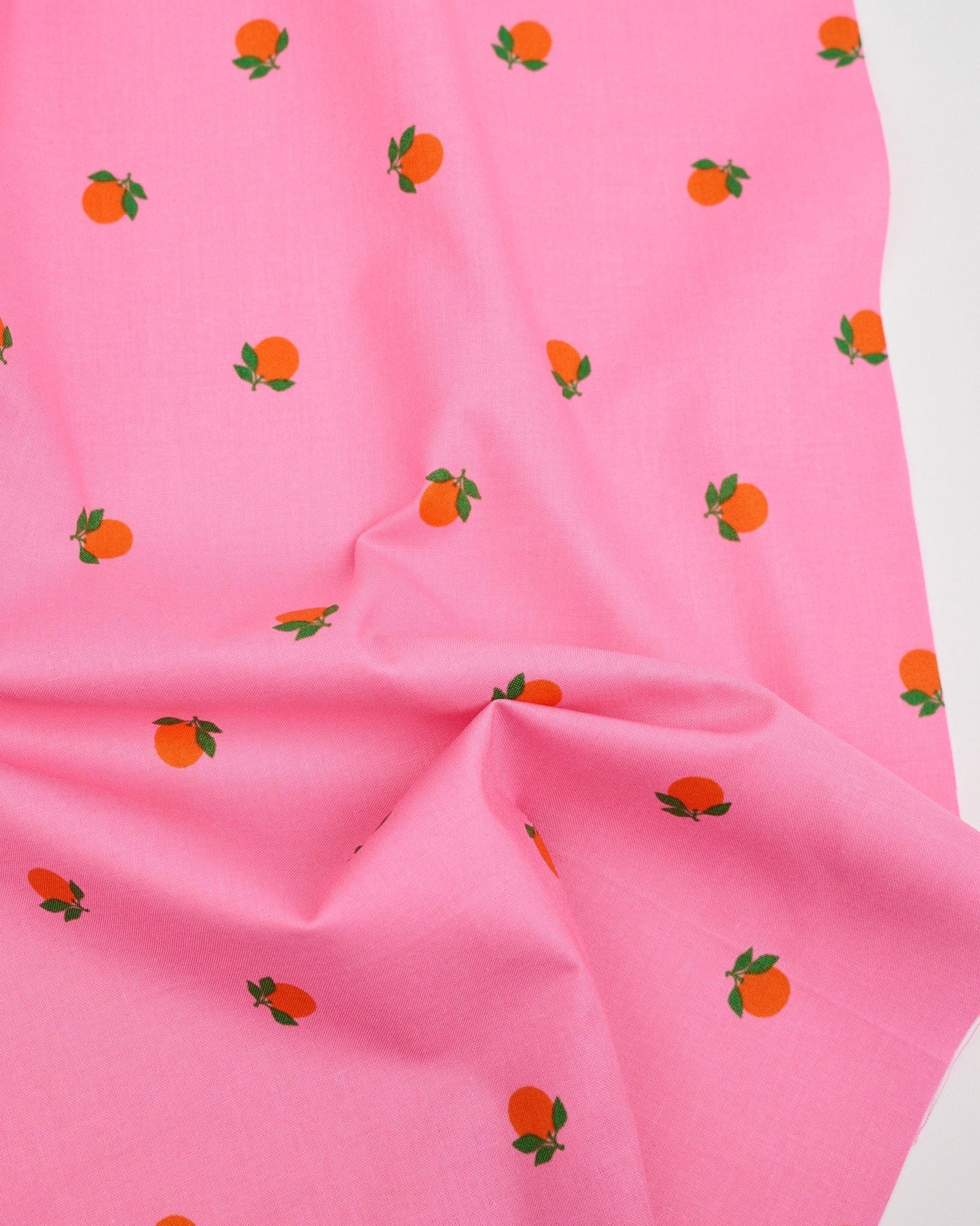 Cotton quilting fabric pattern called 'Tangerines in June'. Part of the 'Rise and Shine' fabric collection. Designed by Melody Miller of Ruby Star Society for fabric company Moda Fabrics. SKU: RS0082 14. 44-45 inch width.