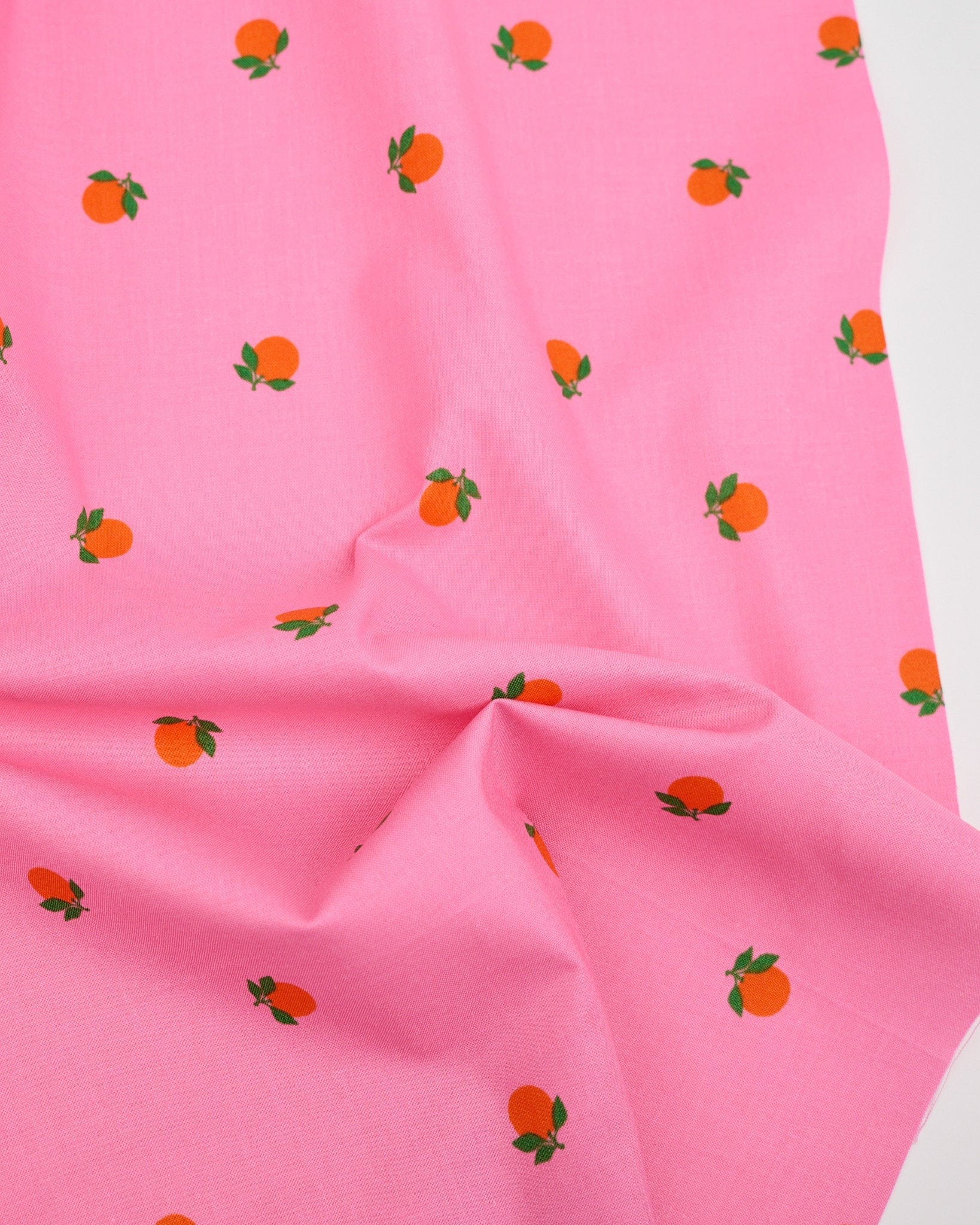 Cotton quilting fabric pattern called 'Tangerines in June'. Part of the 'Rise and Shine' fabric collection. Designed by Melody Miller of Ruby Star Society for fabric company Moda Fabrics. SKU: RS0082 14. 44-45 inch width.