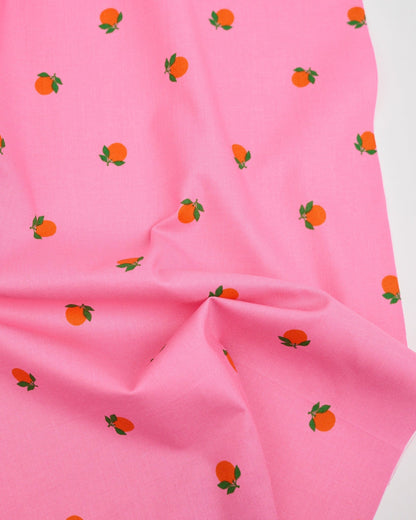 Cotton quilting fabric pattern called 'Tangerines in June'. Part of the 'Rise and Shine' fabric collection. Designed by Melody Miller of Ruby Star Society for fabric company Moda Fabrics. SKU: RS0082 14. 44-45 inch width.