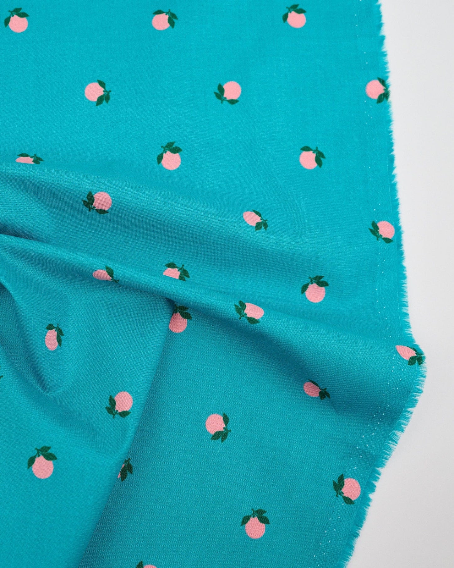 Cotton quilting fabric pattern called 'Tangerines in Succulent'. Part of the 'Rise and Shine' fabric collection. Designed by Melody Miller of Ruby Star Society for fabric company Moda Fabrics. SKU: RS0082 16. 44-45 inch width.