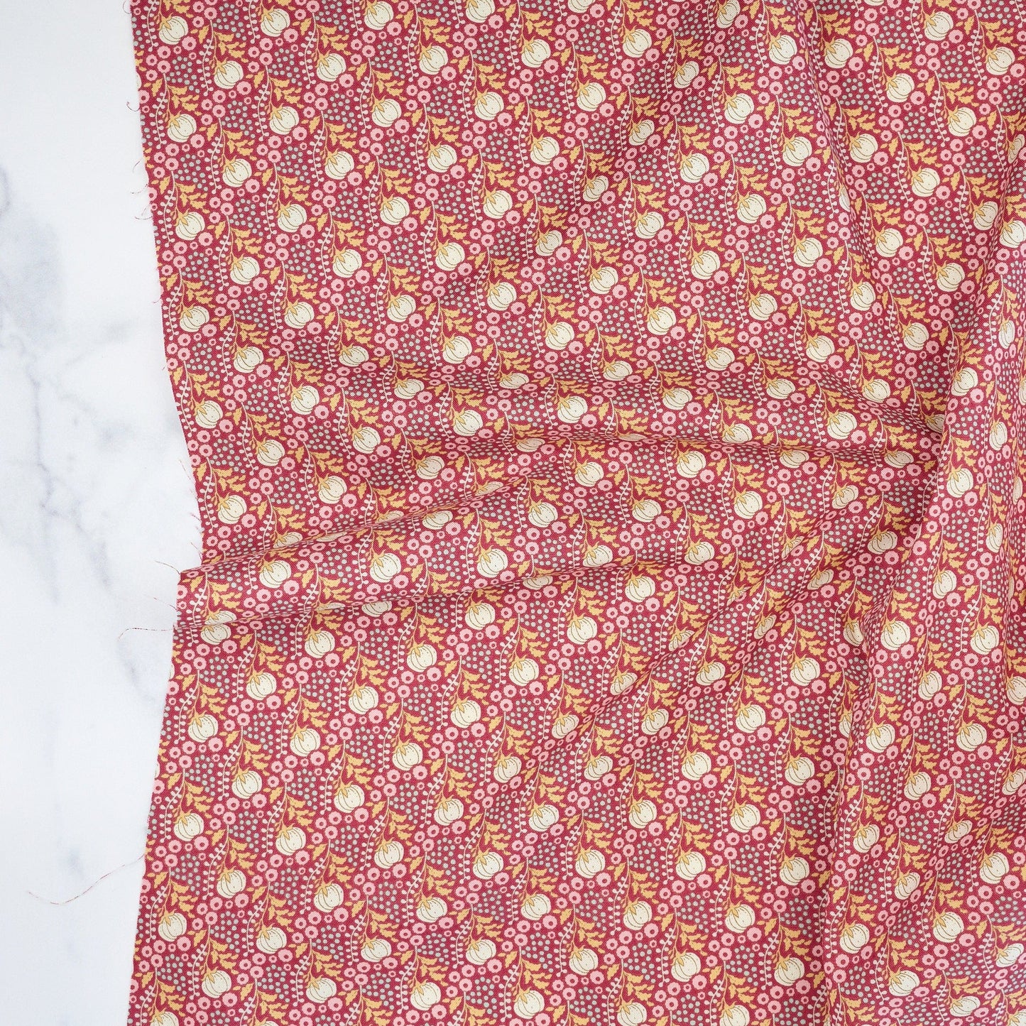 Cotton quilting fabric pattern called 'Cottonfield Maroon'. Part of the 'Sanctuary' fabric collection. Designed by Tone Finnanger for fabric company Tilda Fabrics. SKU: TIL100564. 44-45 inch width.