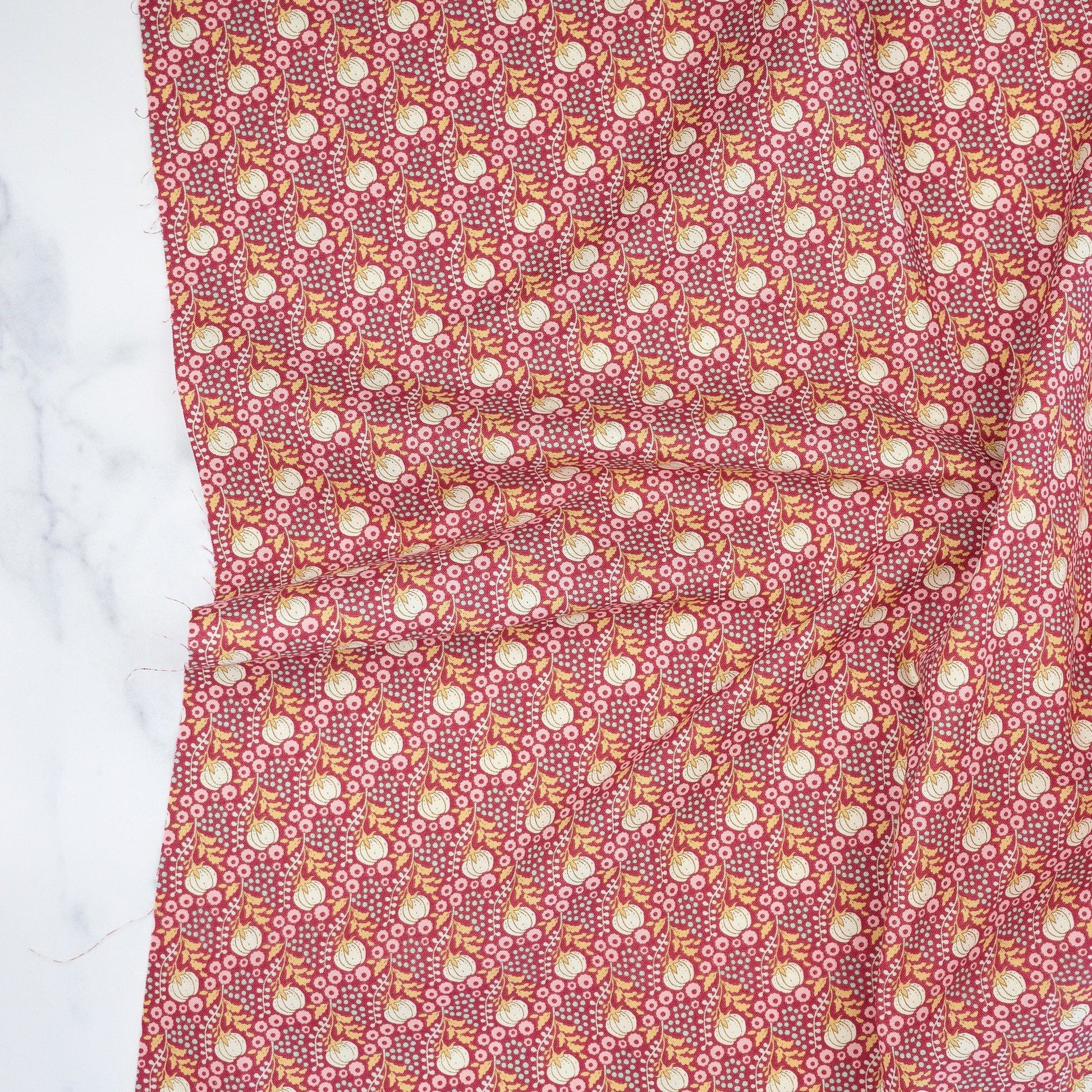 Cotton quilting fabric pattern called 'Cottonfield Maroon'. Part of the 'Sanctuary' fabric collection. Designed by Tone Finnanger for fabric company Tilda Fabrics. SKU: TIL100564. 44-45 inch width.