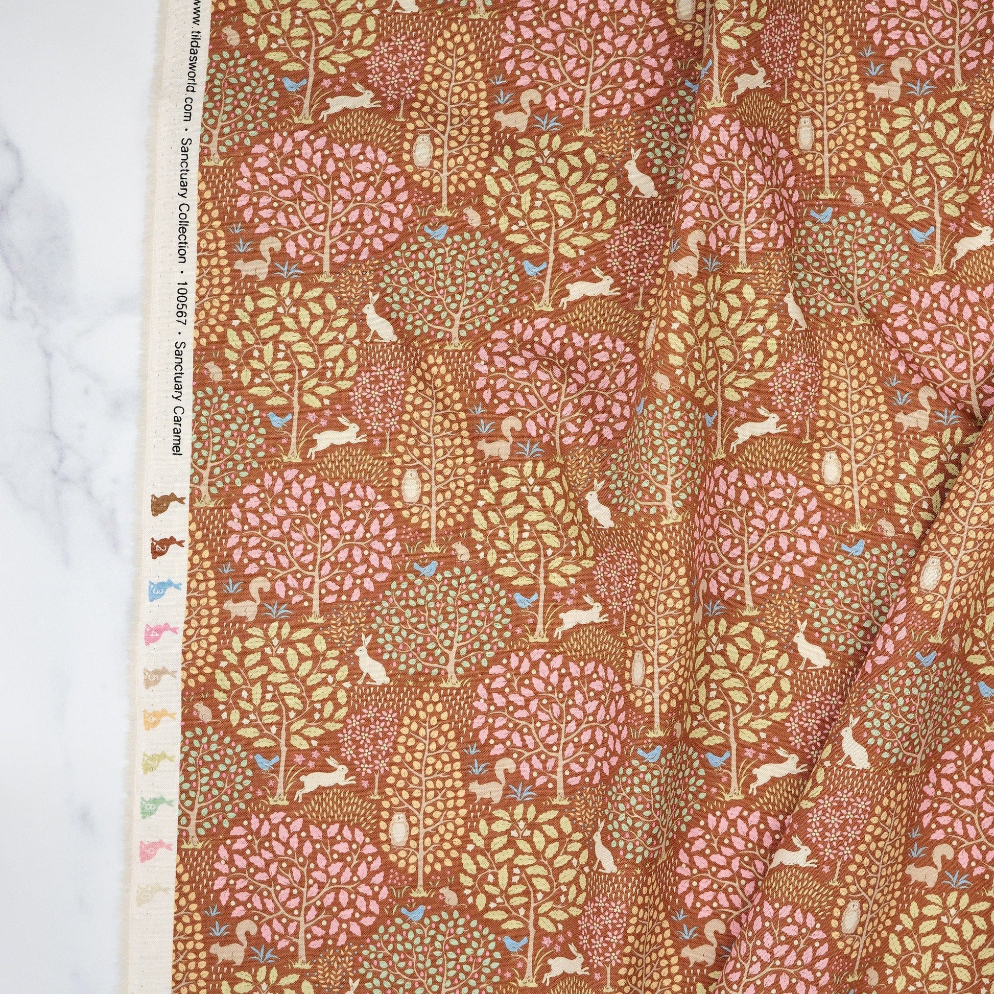 Cotton quilting fabric pattern called 'Sanctuary Caramel'. Part of the 'Sanctuary' fabric collection. Designed by Tone Finnanger for fabric company Tilda Fabrics. SKU: TIL100567. 44-45 inch width.