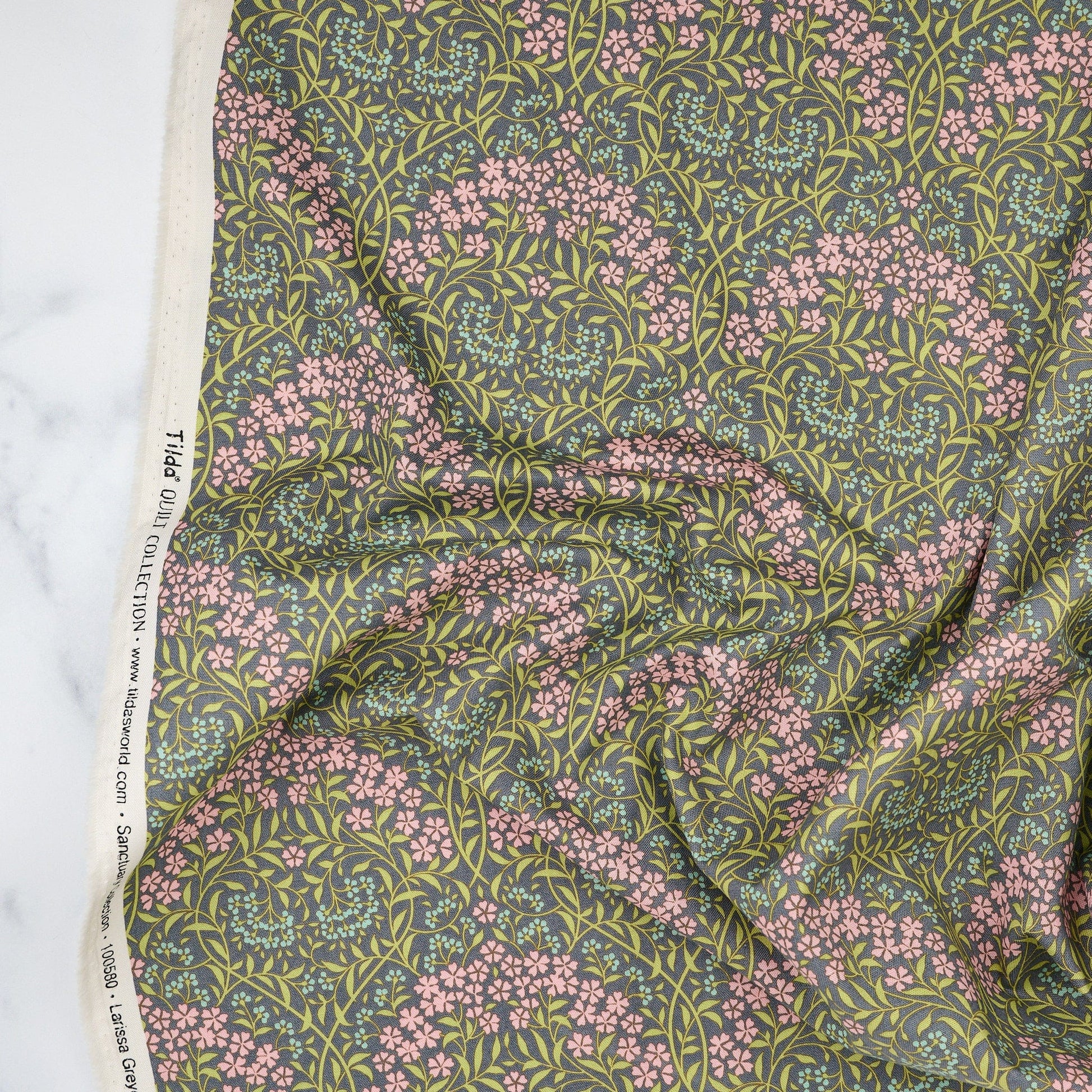 Cotton quilting fabric pattern called 'Larissa Grey-Green'. Part of the 'Sanctuary' fabric collection. Designed by Tone Finnanger for fabric company Tilda Fabrics. SKU: TIL100580 . 44-45 inch width.