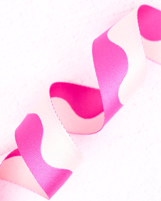 Close-up of bright pink and white two-tone nylon wavy pattern webbing for bag making, straps and accessories, by Renaissance Ribbons