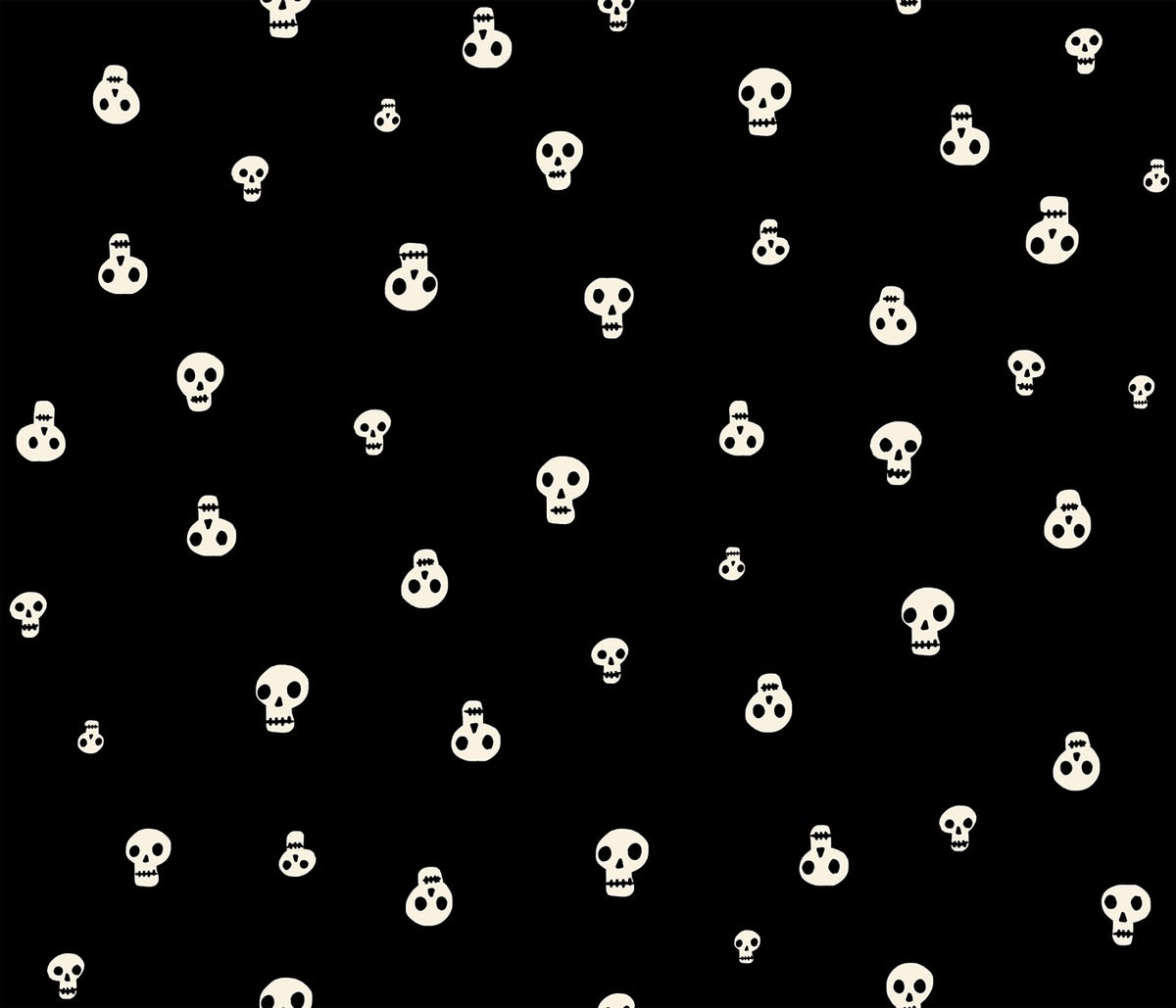 Moda's Halloween stylized cream skulls of varying sizes on black Boo Valley by Ruby Star Society's Alexia Abegg cotton quilting fabric