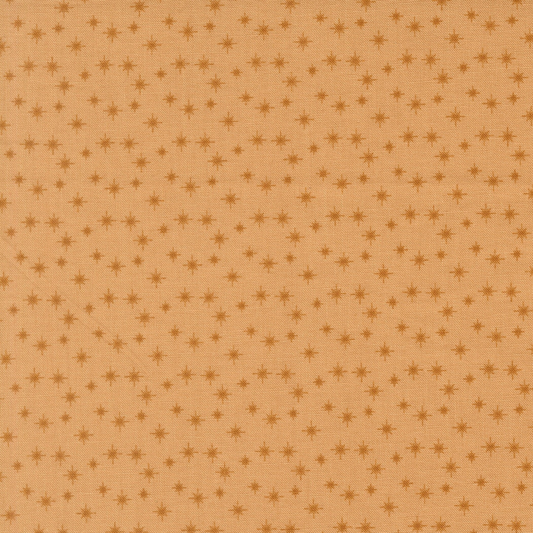 Moda's small cookie stars December Darling by My Sew Quilty Life cotton quilting fabric with scattered dark tan stars on light brown.