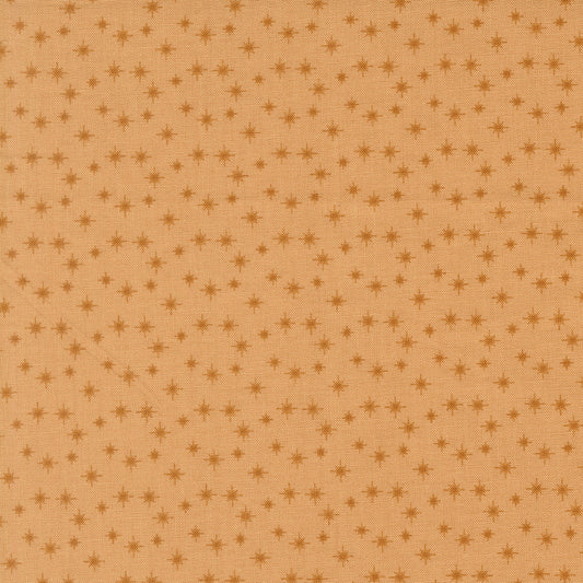 Moda's small cookie stars December Darling by My Sew Quilty Life cotton quilting fabric with scattered dark tan stars on light brown.