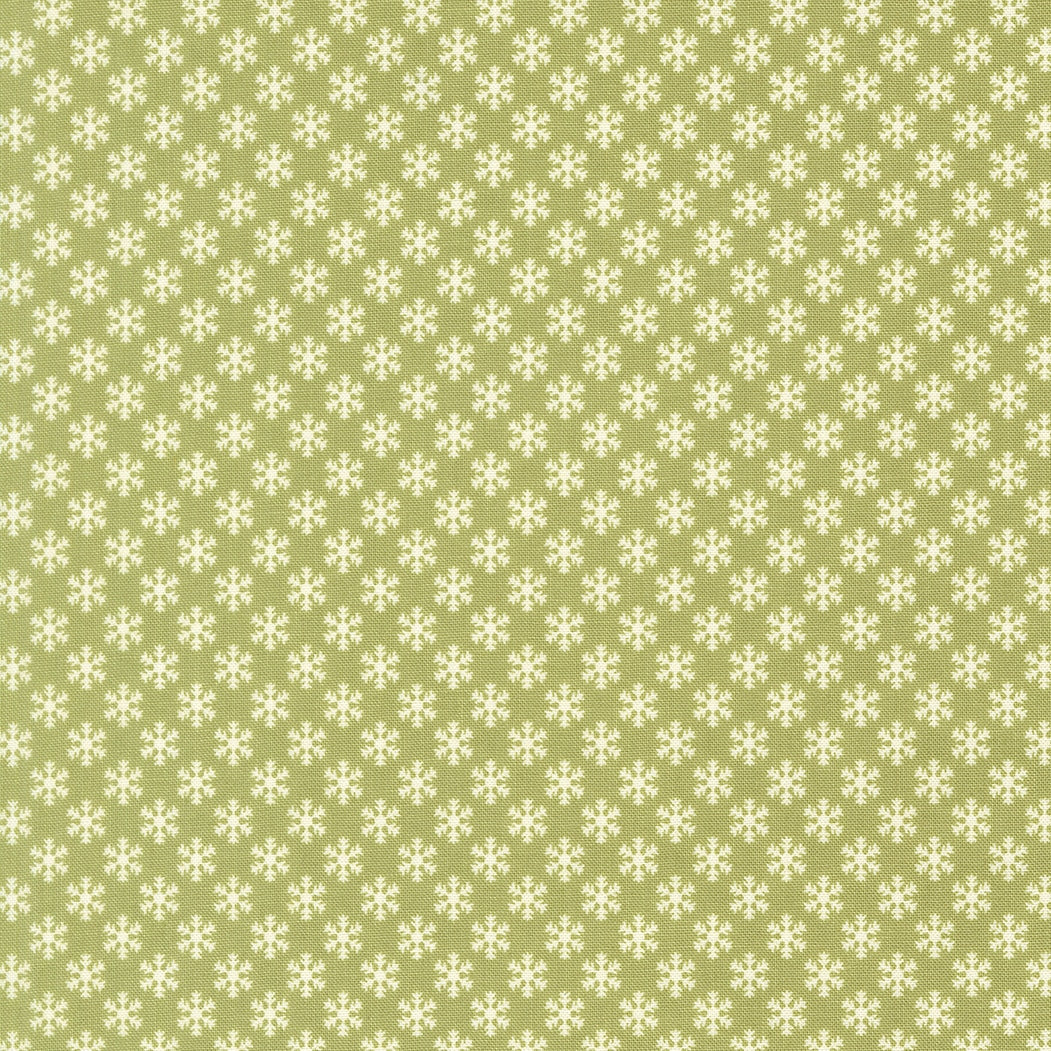 December Darling Christmas snowflakes on sage green cotton quilting fabric by My Sew Quilty Life. Features small, stylized ivory snowflakes in a geometric pattern.