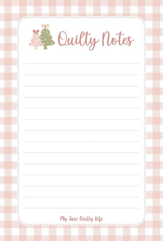 Christmas notepad panel with gingham trees December Darling by Briggs, Heather quilting fabric. White notepad, pink gingham trees with bows.